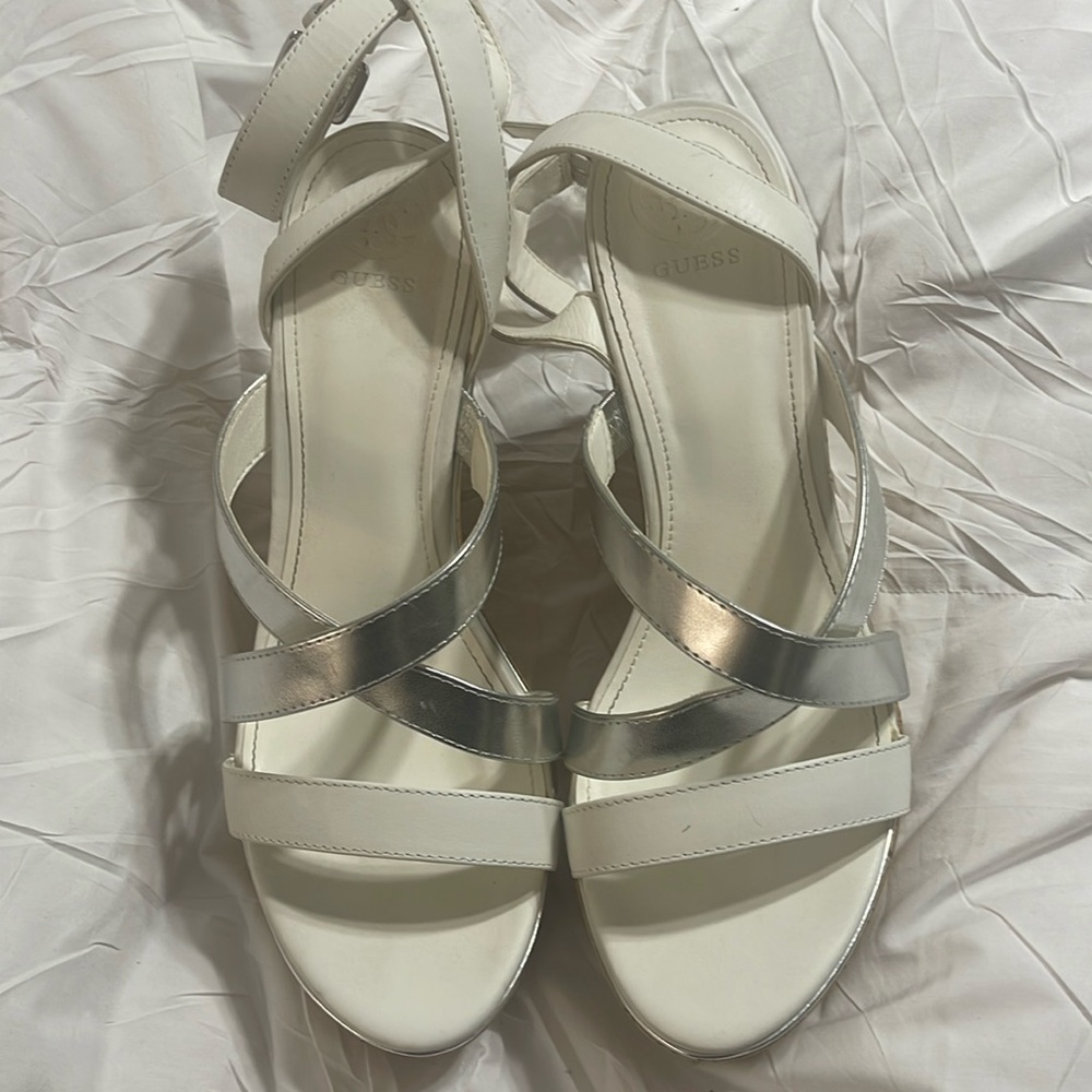 Wedge white and silver gently used sexy shoes. About 4 /2 feet tall. Guess shoes